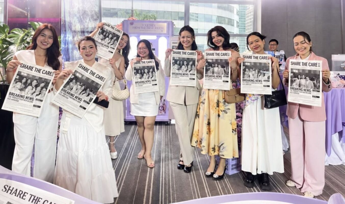 Guests holding personalised newspaper prints from the Newspaper Photo Booth