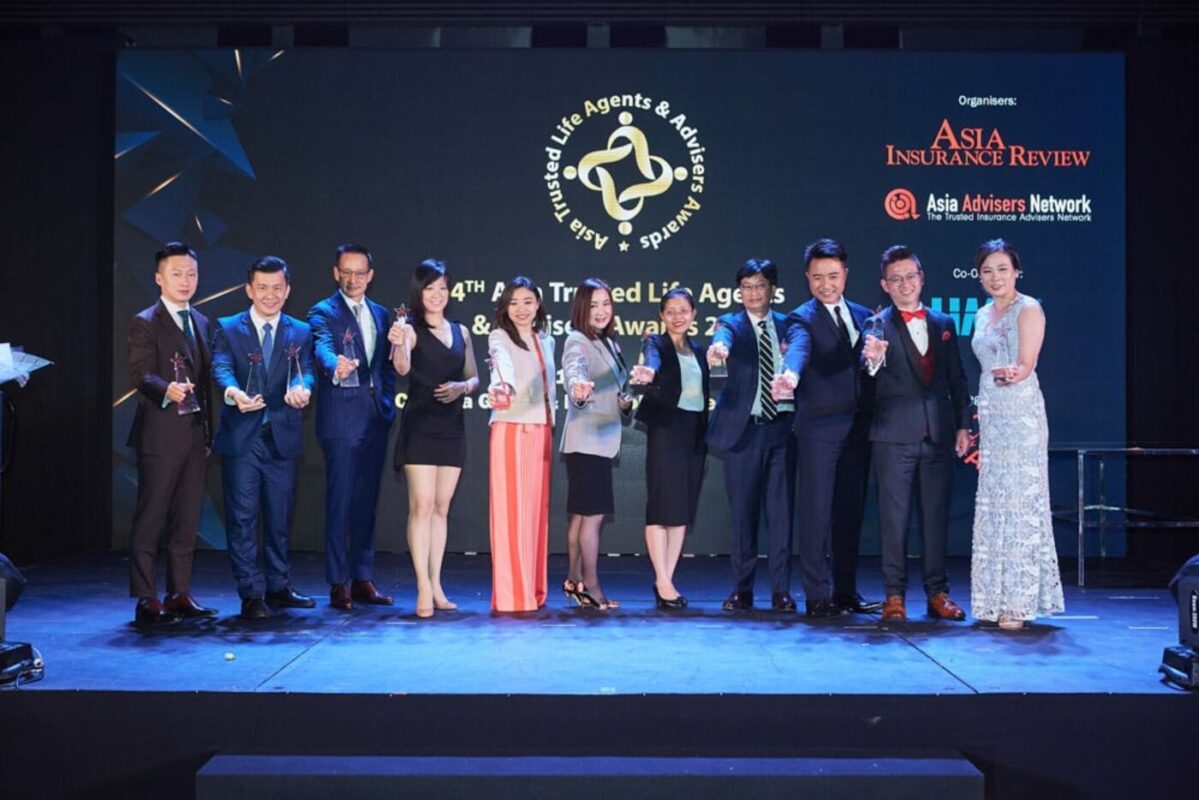 Award ceremony group photo on stage at a corporate event in Bangkok
