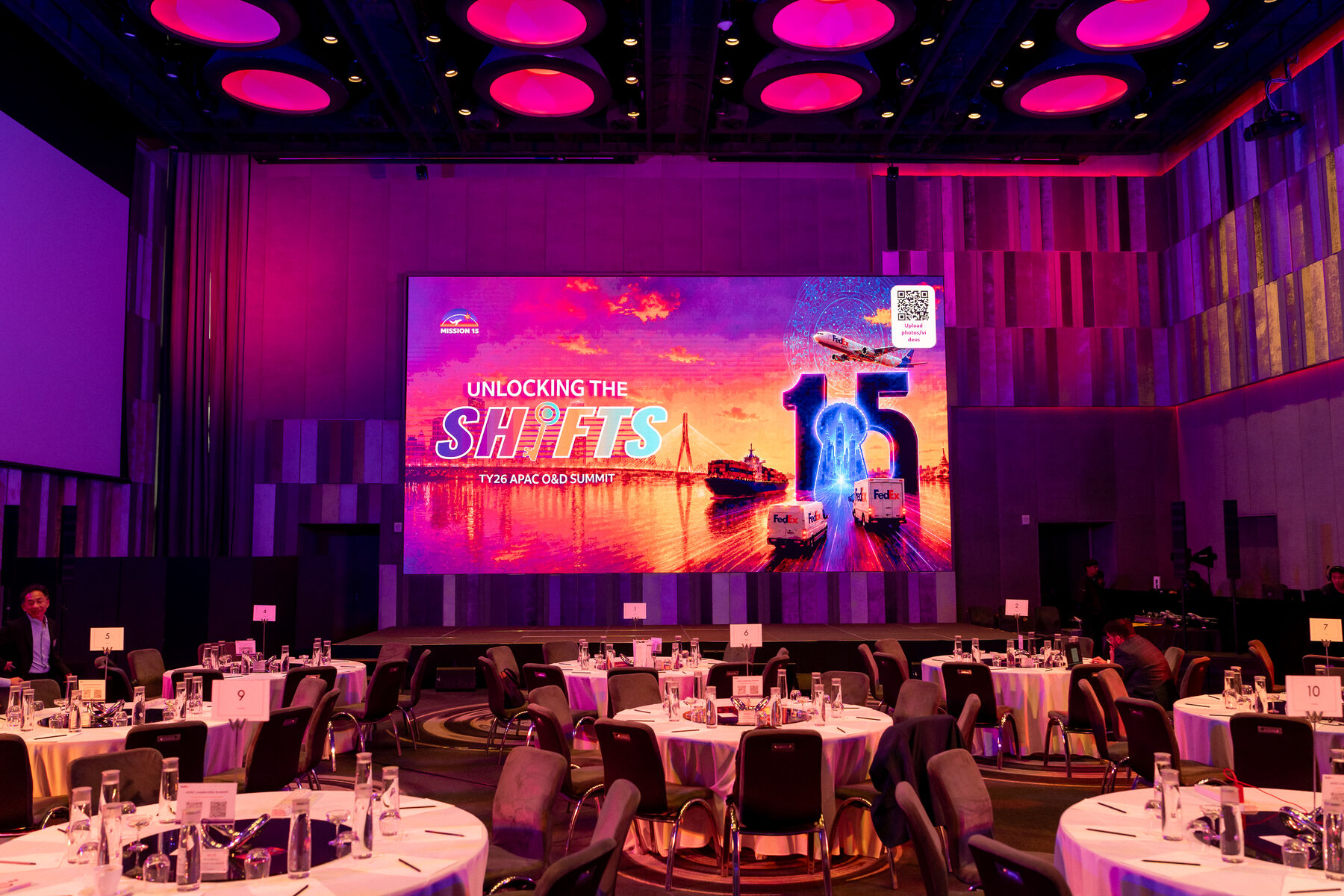 FedEx corporate gala dinner ballroom with stage screen